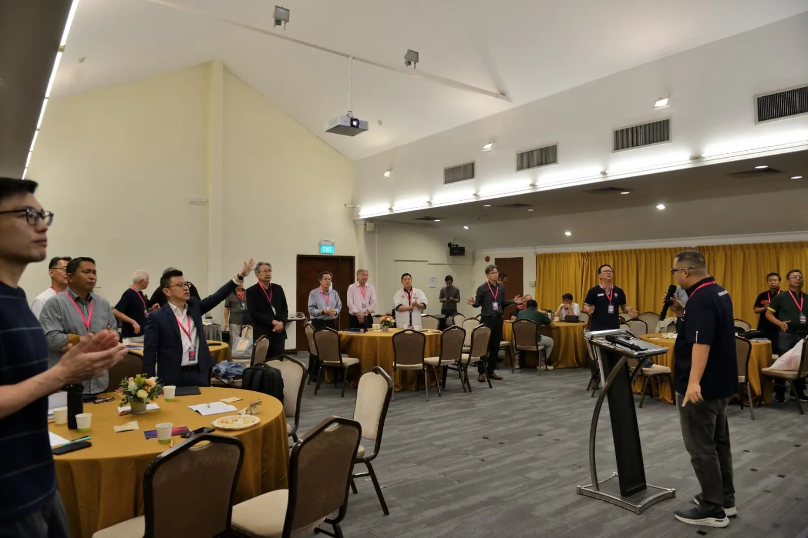 Members standing in worship across the room